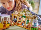 Child playing with LEGO cafe interior.