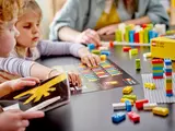 Children using Braille Bricks reference sheet.