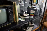 LEGO Polaroid camera on a vintage shelf.