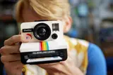 Person holding LEGO Polaroid camera.