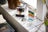 LEGO Polaroid camera on a tiled surface.