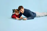 Father and son playing LEGO.