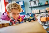 Child playing with LEGO police set.