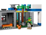 Jail cell with prisoner and tree.