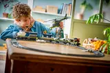 Child playing with LEGO train.