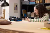 Kid playing with RC Porsche.