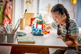 Child admiring LEGO carp set.