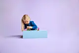 Child intently building and playing.