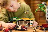Child playing with ATV and building.