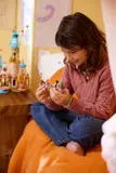Child holding LEGO boat.