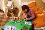 Child building LEGO castle.