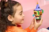 Child holding closed tower.