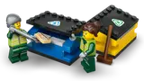 Minifigures sorting recyclables into blue and yellow bins.