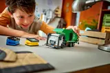 Child playing with LEGO Recycling Truck, front view.