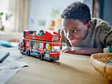 Child playing with LEGO bus.