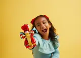 Child playing with LEGO Dragon.