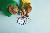 Overhead view of LEGO building with digital instructions.