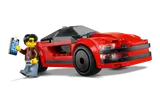 Minifigure Kai taking a photo of his red LEGO sports car.