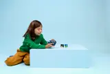 Child playing with LEGO Retro Gaming Console.