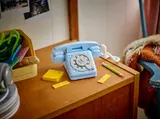 Retro telephone on a wooden nightstand.