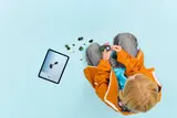 Child building with digital instructions.
