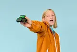 Child playing with LEGO Gaming Race Car.