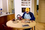 Builder working on LEGO bike.