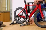 Adjusting LEGO bike on stand.