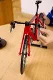 Assembling LEGO bike handlebars.