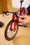 Adjusting LEGO bike front wheel.