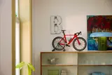 LEGO bike on display shelf.