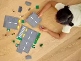Child building LEGO road plates.