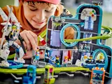Close-up of child playing with LEGO set.