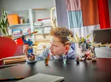 Child playing with the large blue mech.
