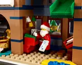 Santa reviews mail, elf peeks.