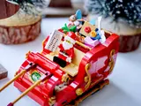 Close-up of Santa in sleigh with gifts.