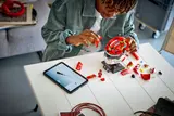 Man building LEGO Leclerc Helmet.
