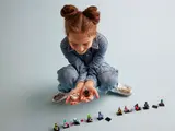 Child playing with LEGO Series 26 minifigures.