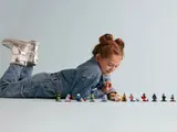 Child observing LEGO Series 26 minifigures.