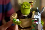Shrek holding an onion.