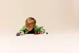 Child playing with LEGO Star Wars set.
