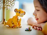 Child and Simba cub face-to-face.