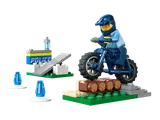A police officer on a dirt bike jumping over logs.