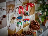 Snowmen hanging from a branch as ornaments.