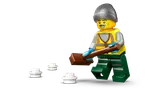 Minifigure with shovel and snow.