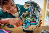 Boy interacting with open LEGO Soccer Ball stadium.