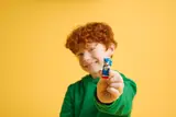 Child holding Sonic minifigure.