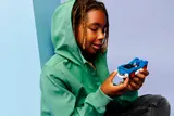 Child happily holds Sonic car.