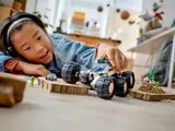 Child playing with rover on floor.