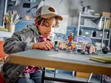 Child playing with LEGO set.